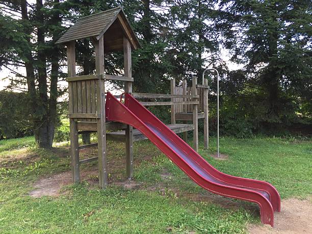 istock wooden playground equipment with slide 592035360