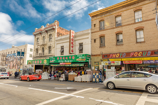 San Francisco, CA, USA - August 17, 2016: Jackson street is the main street for local residents daily shopping. A lot grocery stores and restaurants on the sides. Local residents and tourists walk on the street.