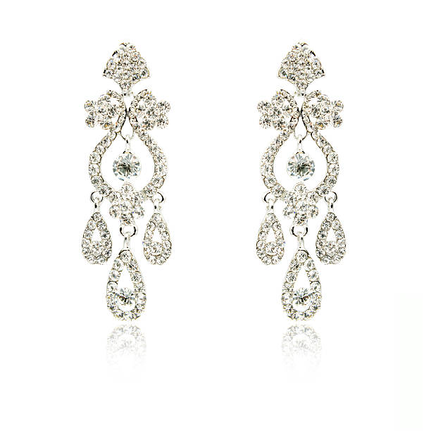 istock Pair of silver diamond earrings isolated on white 592358370