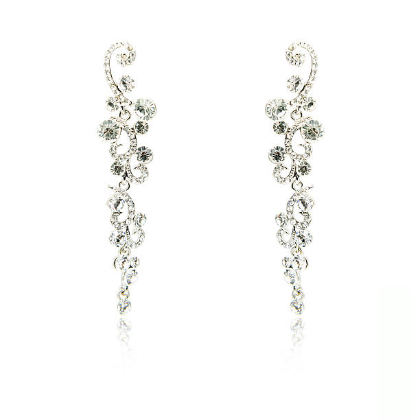 istock Pair of silver diamond earrings isolated on white 592358688