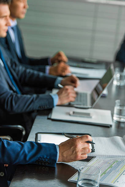istock Businessmen writing notes on a meeting 592358998