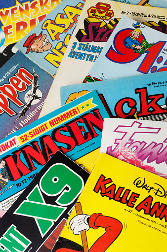 Stockholm, Sweden - August 21, 2016: Collage of Swedish comic books from the 1970s and 1980s, including Archie, Asa Nisse, Batman, the Phantom, 91 Karlsson, Donald Duck, Beetle Bailey, Superman and Agent X9.