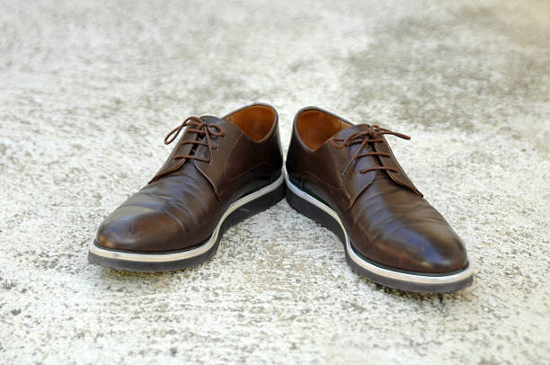 istock Male shoes on cement background 592359340