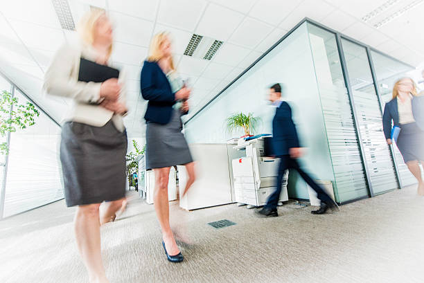 istock Business people in a hurry in office corridor 592359812