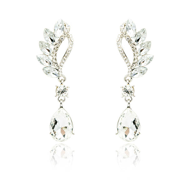 istock Pair of silver diamond earrings isolated on white 592359990