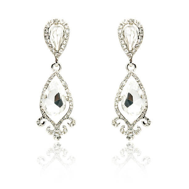 istock Pair of silver diamond earrings isolated on white 592360362