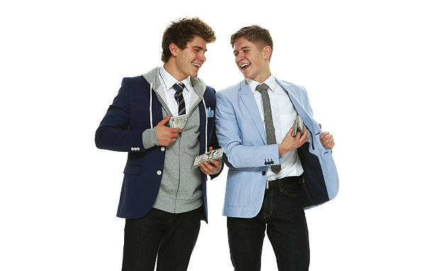 istock Cheerful brothers holding money 592360940