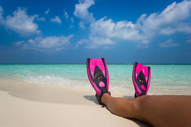 istock Woman relaxing on summer beach vacation holidays lying in sand. 592361064