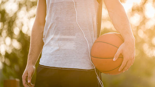 istock Young man holding basketball 592361828