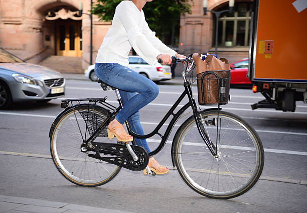 Stockholm, Sweden - June 20, 2016: Modern female bicyclist in profile in environment friendly central Stockholm, Vasagatan. Panning blur.  In traffic.