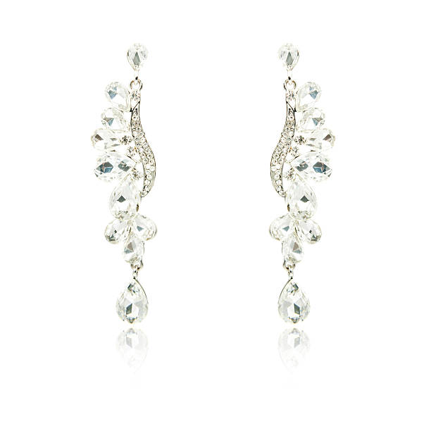 istock Pair of silver diamond earrings isolated on white 592362864