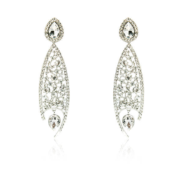 istock Pair of silver diamond earrings isolated on white 592363444