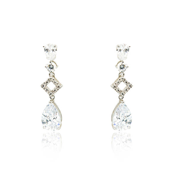istock Pair of silver diamond earrings isolated on white 592363482