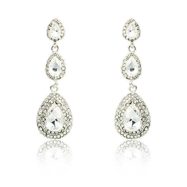 istock Pair of silver diamond earrings isolated on white 592363570