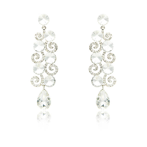 istock Pair of silver diamond earrings isolated on white 592363616