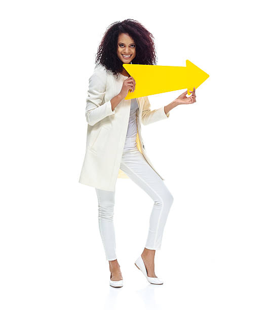 istock Cheerful woman holding arrow sign 592364462