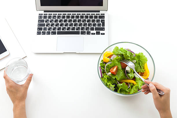 istock Woman eating salad and drinking water. 592365182