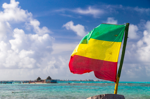 Jamaica flag at tropical beach.