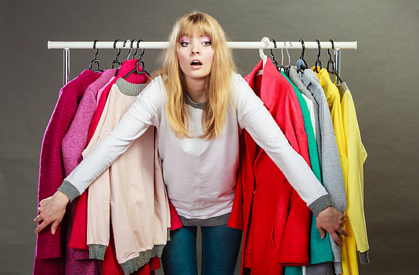istock Pretty woman between new clothes. 592366052