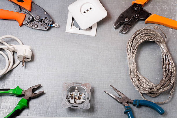 istock Set of electrical tool on wooden background. Accessories for engineering 592369610