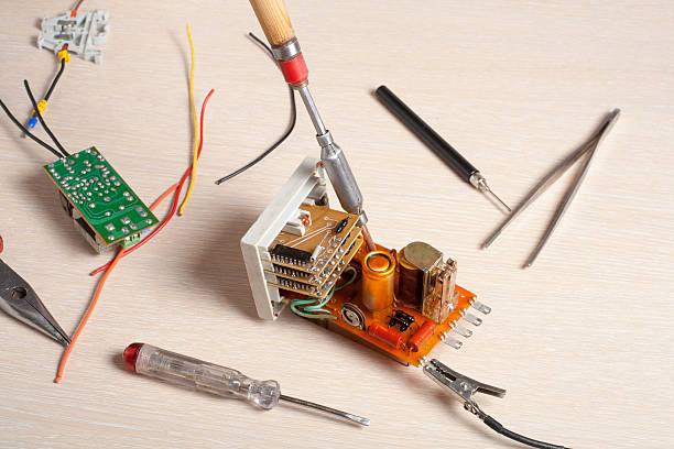 istock Set of electrical tool on wooden background. Accessories for engineering 592370424
