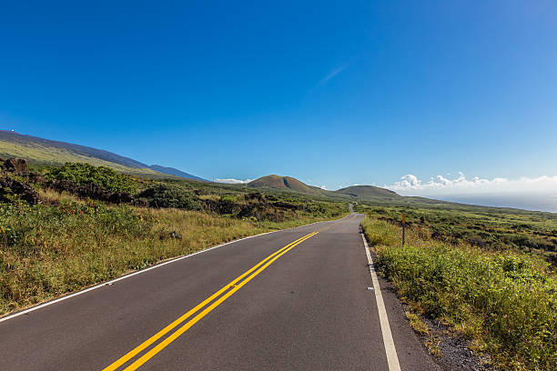 istock Open roadtrip road with mountains and ocean 592371730