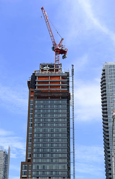 istock Crane at construction site of new commercial building 592371960