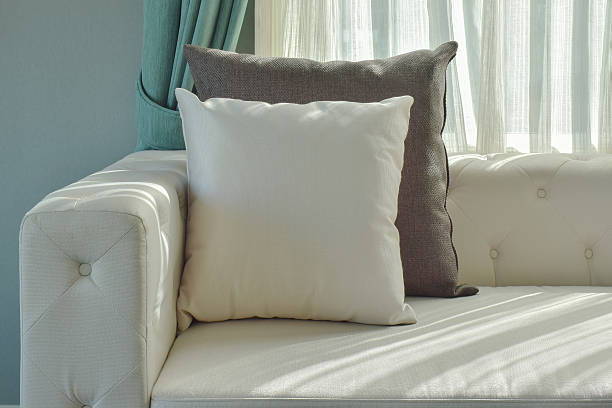 istock Black and gray pillow on beige sofa with natural light 592373838