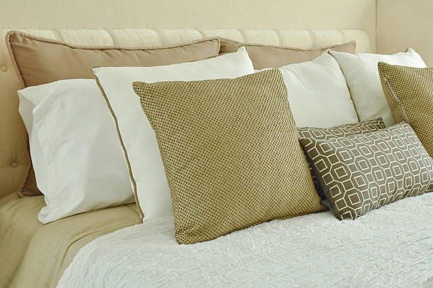 istock Modern classic style bedding with brown shade pillows on bed 592373938
