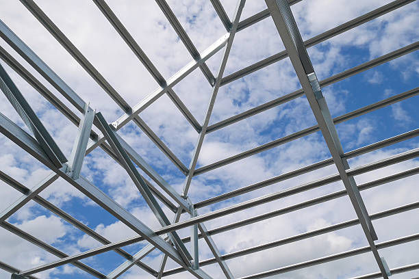 Structure of steel roof frame with blue sky and clouds stock photo