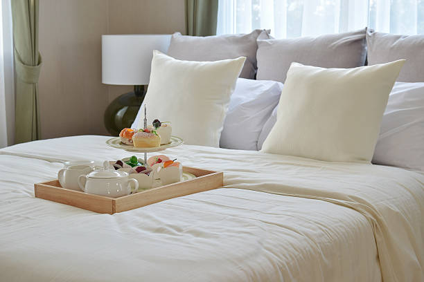 istock bedroom interior with decorative tea set and dessert on bed 592374810