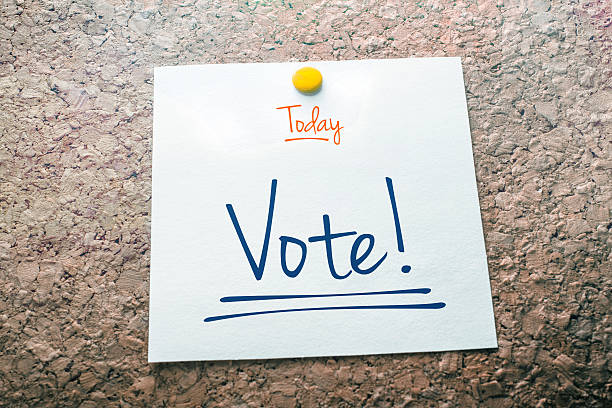 Vote Reminder For Today On Paper Pinned On Cork Board stock photo