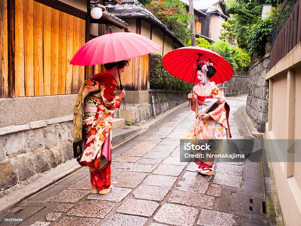 beautiful Maiko ladies in Kyoto. greeting of two young maiko ladies in the old street in Kyoto. Geisha Stock Photo