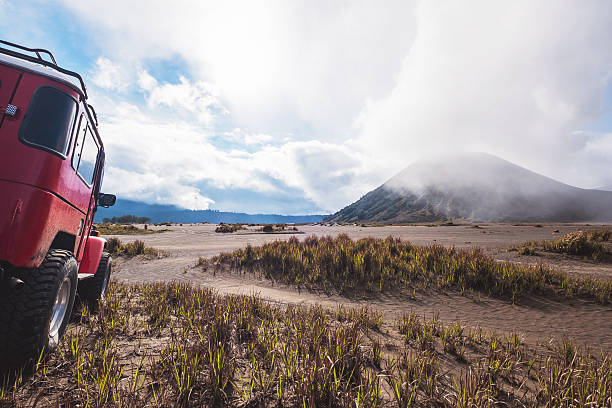 Red off road car at Bromo mountain, adventure trial