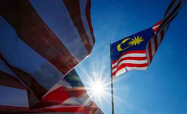 Malaysia Flag Malaysia flag also known as Jalur Gemilang wave with the blue sky. People fly the flag in conjunction with the Independence Day celebration or Merdeka Day. malaysia stock pictures, royalty-free photos & images