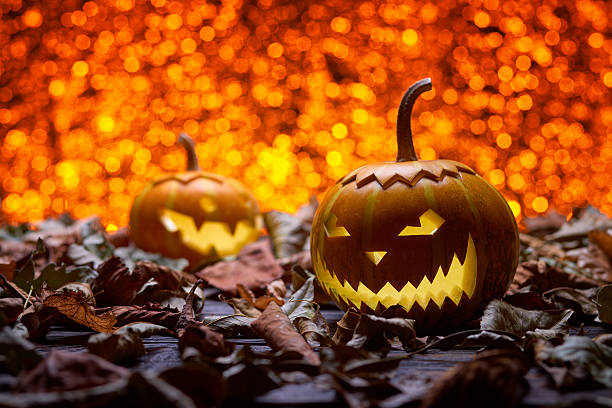 istock Pumpkins for Halloween in the fall foliage 592378550