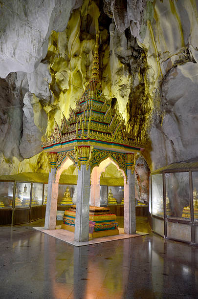istock People praying with buddha statue inside cave 592378924