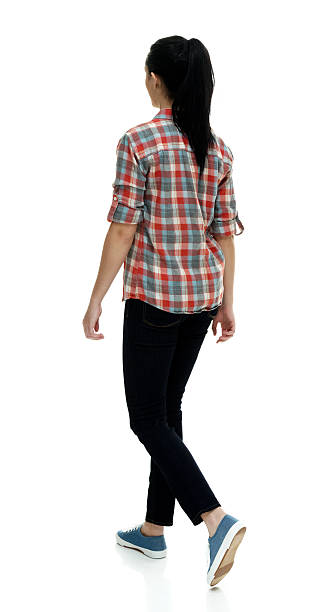 istock Rear view of female walking 592379334