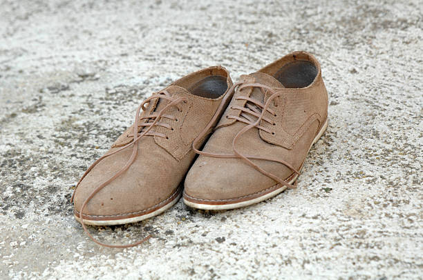istock Male shoes on cement background 592379892