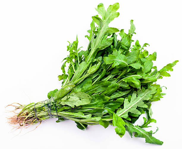 istock bunch of fresh cut green arugula herb on white 592380288
