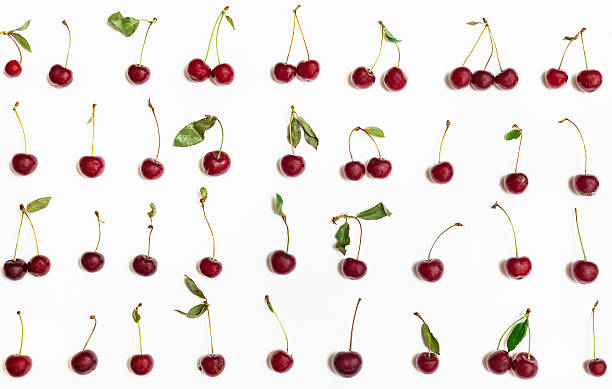 istock many ripe red cherries with green leaves on white 592381618