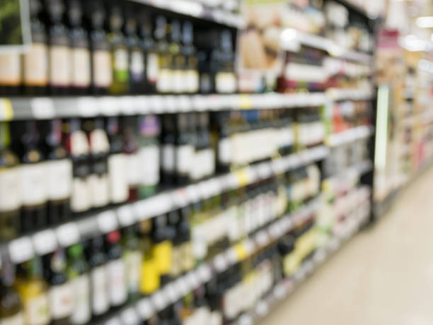 istock Wine bottles on shelf in wine store 592382770