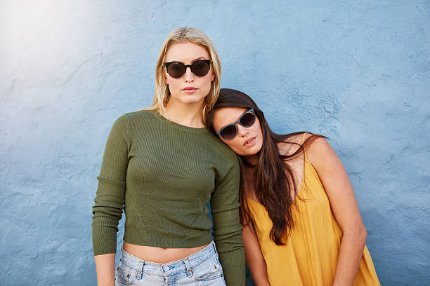 istock Stylish young female models on blue background 592382926