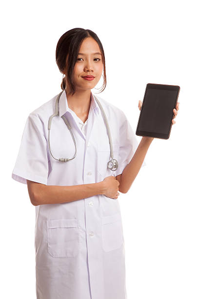 istock Asian young female doctor show tablet pc 592383896
