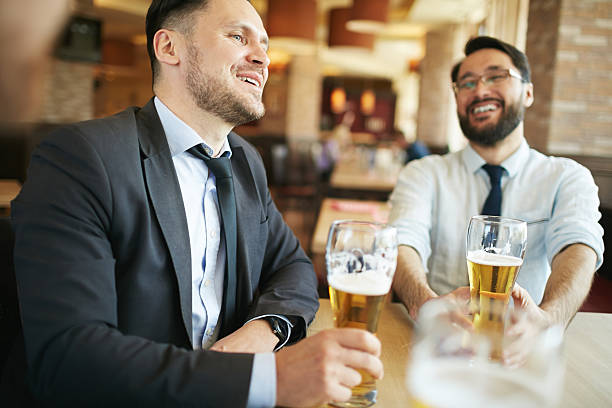 istock Businessman Laughing in Bar 592384606