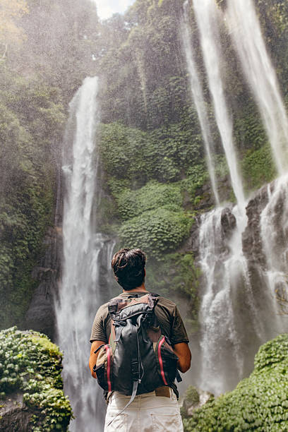 istock Male hiker looking at waterfall 592384654