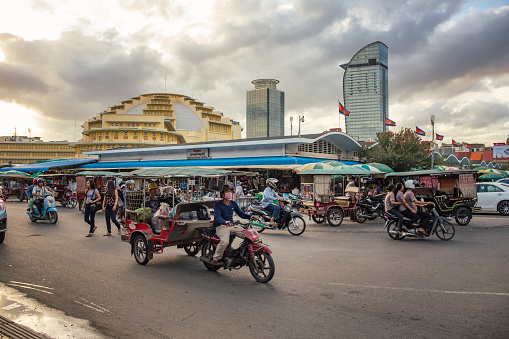 Phnom Penh, Cambodia - August 14, 2016: Candid street scene outside the central market in Phnom Penh. The Central Market in the Cambodian capital was constructed in 1937 in the shape of a dome with four arms branching out into hallways.