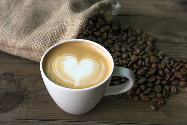 istock Hot coffee cafe latte with coffee beans 592385670