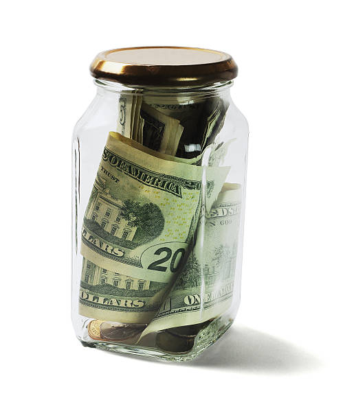 istock US Dollars Bills and Coins in Glass Jar 592387754