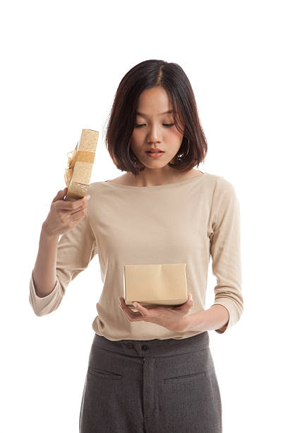 istock Young Asian business woman open a gift box 592387904